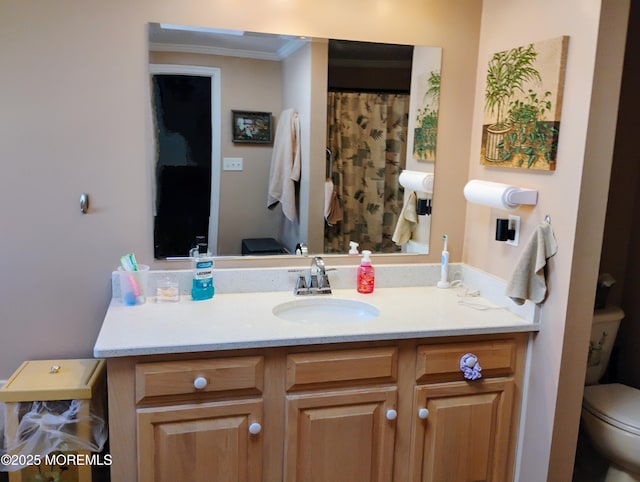 full bath featuring toilet, crown molding, and vanity