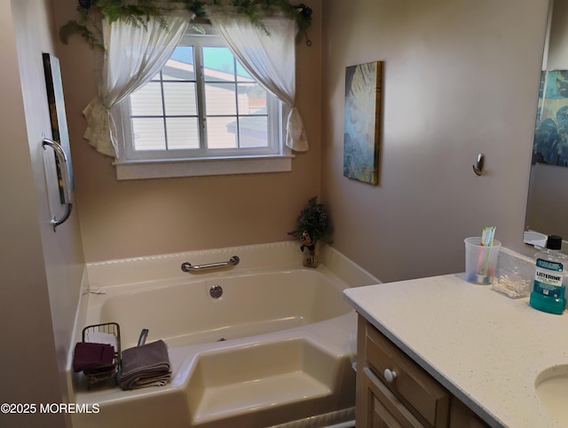 bathroom featuring a garden tub and vanity