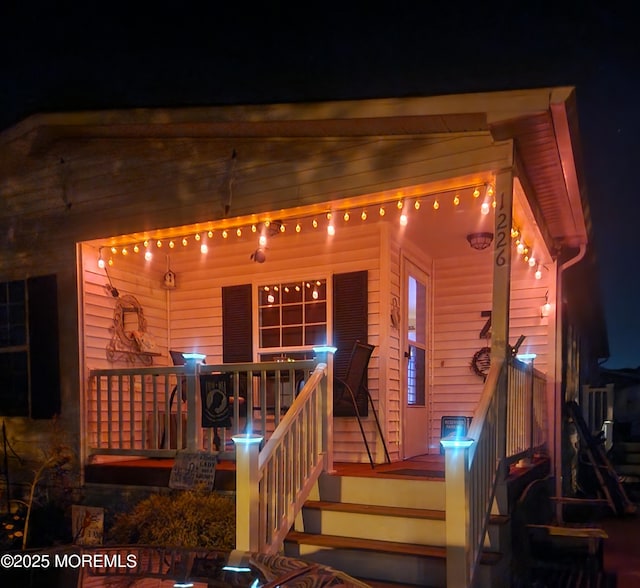 view of exterior entry at night