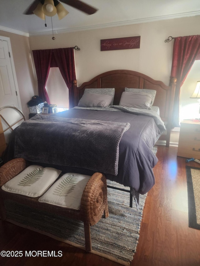 bedroom with a ceiling fan, ornamental molding, and wood finished floors