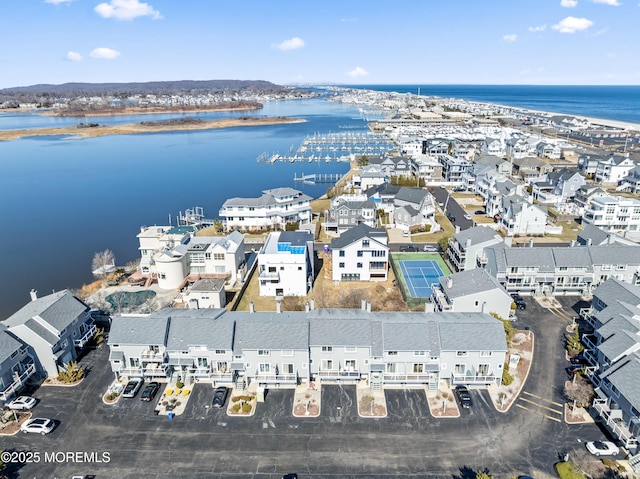 birds eye view of property with a water view and a residential view