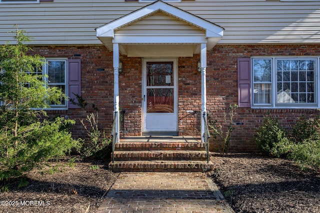 property entrance with brick siding