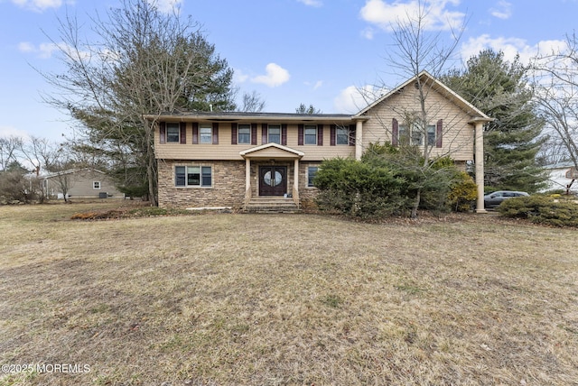 view of front of property with a front yard and stone siding