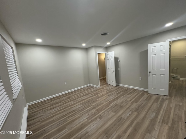 interior space with recessed lighting, visible vents, baseboards, and wood finished floors