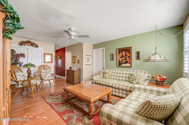 living area with light wood-type flooring and ceiling fan