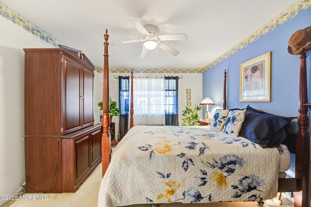 bedroom with light carpet and a ceiling fan