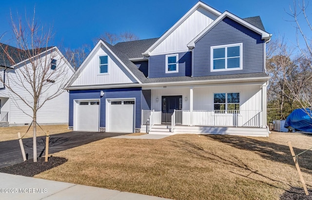 modern inspired farmhouse with aphalt driveway, roof with shingles, covered porch, board and batten siding, and a front lawn