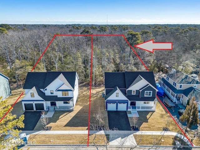 birds eye view of property with a wooded view