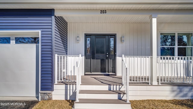 property entrance featuring a garage and a porch