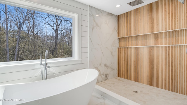 bathroom featuring a freestanding tub, marble finish floor, a shower, and recessed lighting