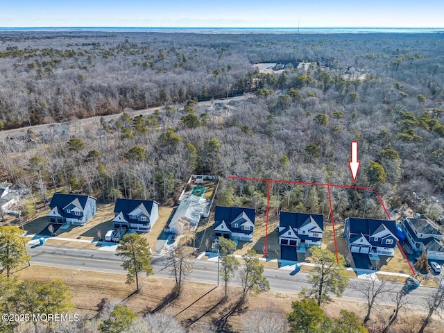 drone / aerial view featuring a forest view