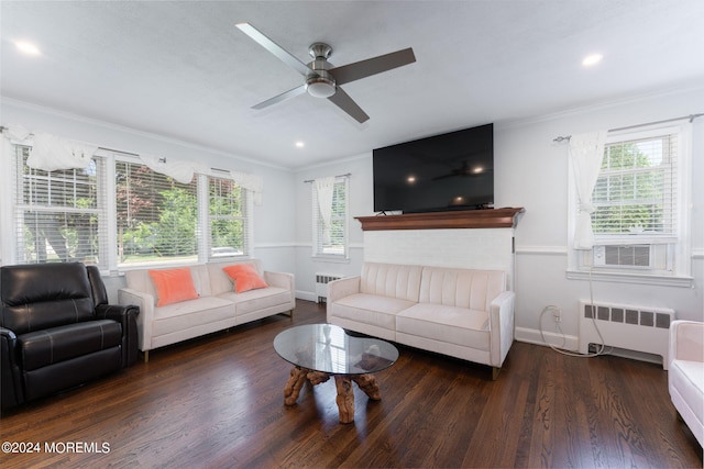 living area featuring ornamental molding, radiator, baseboards, and wood finished floors