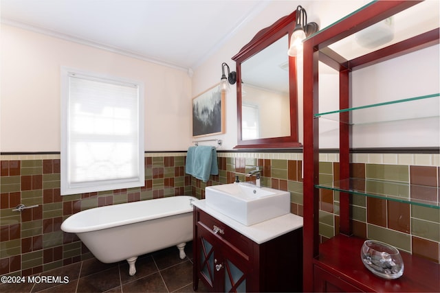 bathroom with tile patterned flooring, vanity, wainscoting, a soaking tub, and tile walls