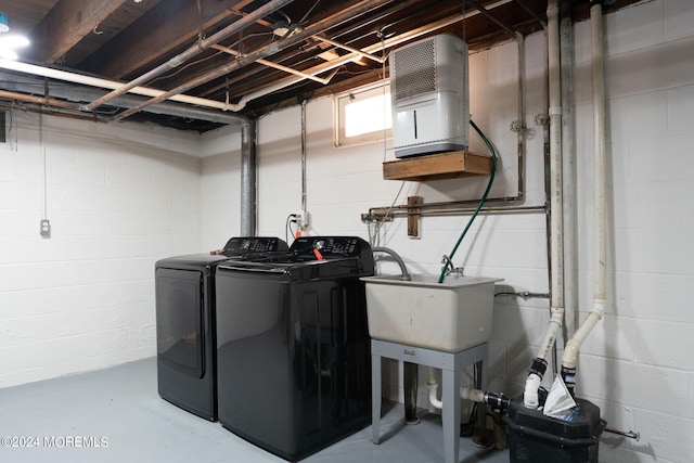 washroom with laundry area, separate washer and dryer, and a sink