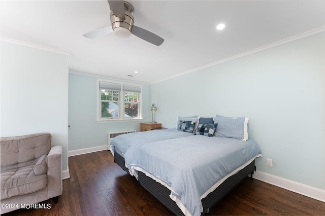 bedroom with radiator heating unit, wood finished floors, and baseboards