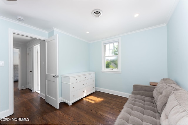 living area featuring dark wood-style floors, visible vents, baseboards, and ornamental molding