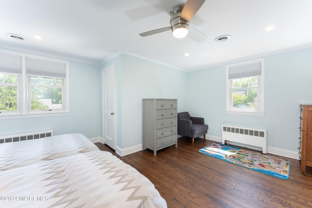 bedroom with dark wood finished floors, baseboards, ornamental molding, and radiator heating unit