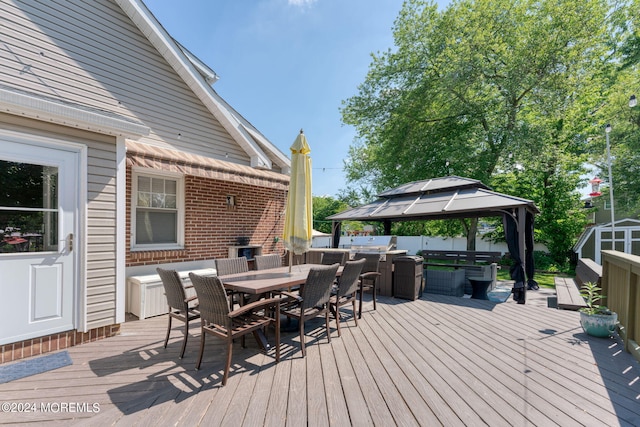 deck featuring a gazebo and outdoor dining area