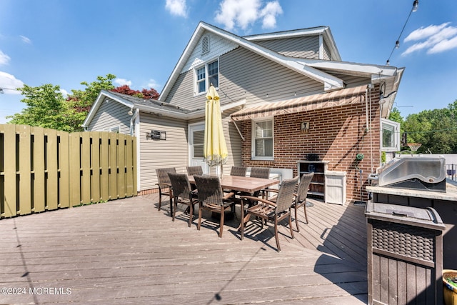 wooden deck featuring outdoor dining area