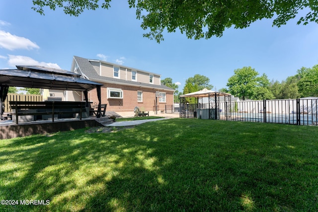 view of yard featuring a gazebo, a patio area, and fence