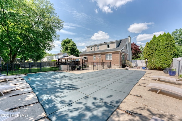 view of swimming pool with a gazebo, a patio area, and fence