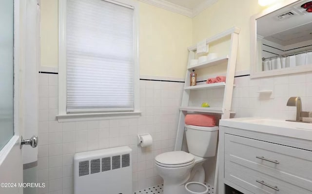 bathroom with toilet, radiator heating unit, tile walls, crown molding, and vanity