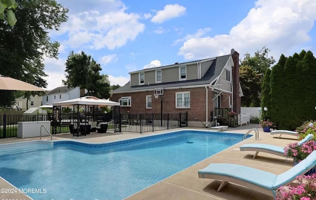 view of swimming pool with a patio, fence, and a fenced in pool