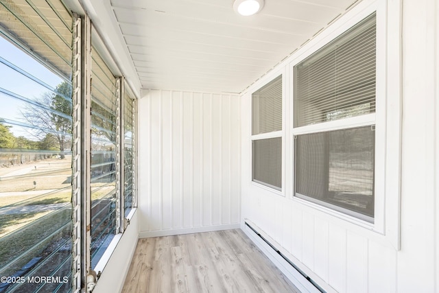 unfurnished sunroom with baseboard heating