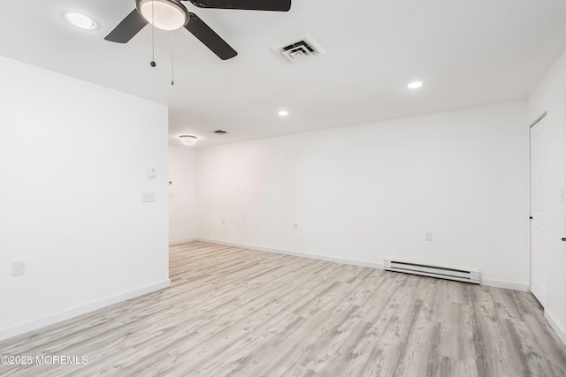 empty room featuring recessed lighting, visible vents, a baseboard heating unit, light wood-style floors, and baseboards