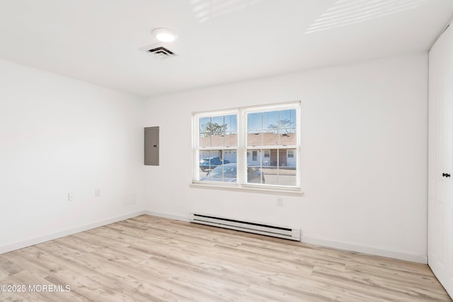 unfurnished room with wood finished floors, visible vents, baseboards, baseboard heating, and electric panel