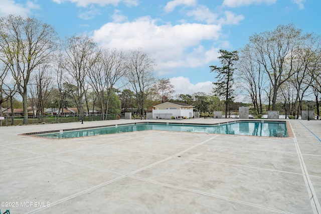 pool featuring a patio and fence