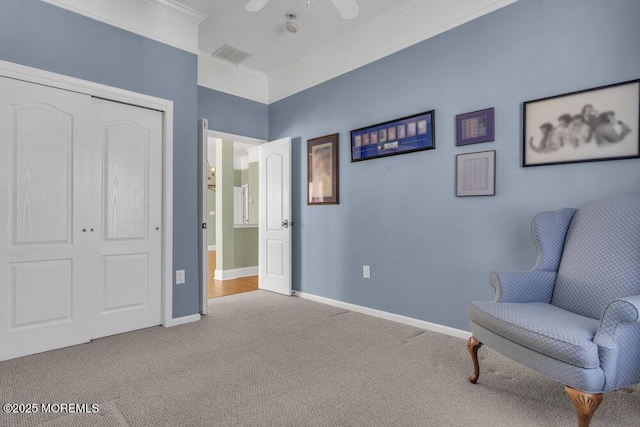 sitting room featuring carpet floors, ornamental molding, visible vents, and baseboards