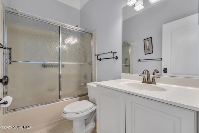 bathroom featuring toilet, shower / bath combination with glass door, vanity, and tile patterned floors