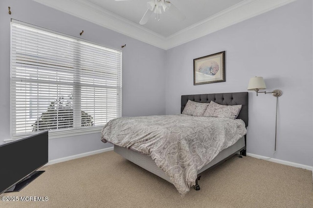 carpeted bedroom with ceiling fan, ornamental molding, and baseboards