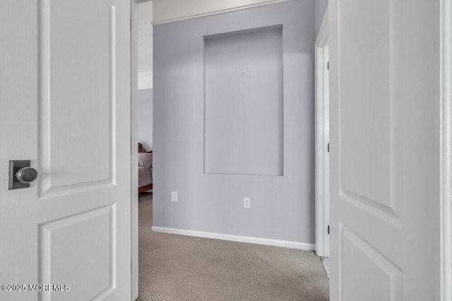 hall with carpet floors and baseboards