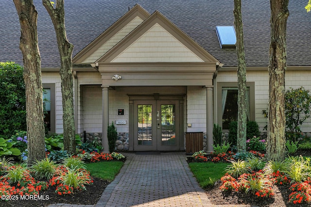 doorway to property with french doors and roof with shingles