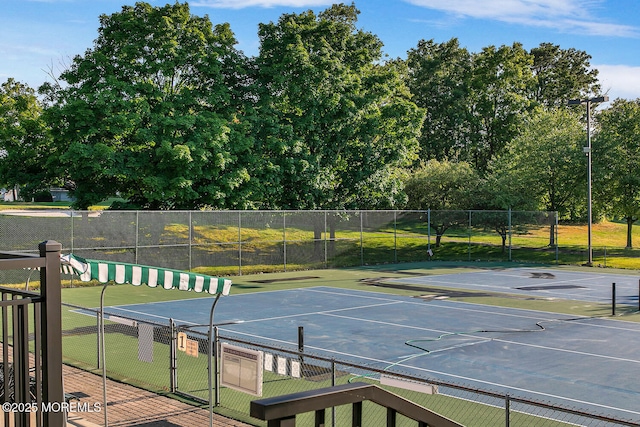 view of sport court with fence and a gate