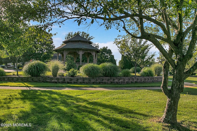 surrounding community with a gazebo and a lawn