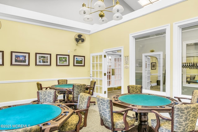 playroom with a chandelier, french doors, and carpet floors