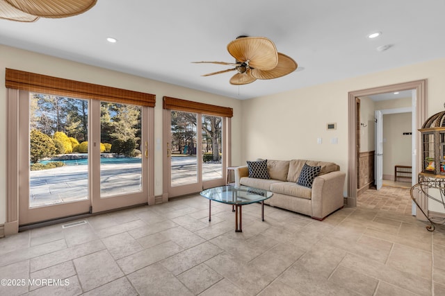 living room featuring recessed lighting, visible vents, stone tile floors, and ceiling fan