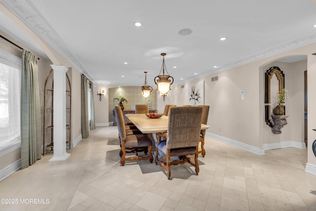 dining room featuring crown molding, recessed lighting, arched walkways, and ornate columns