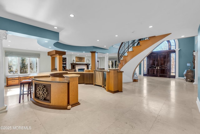 kitchen with decorative columns, recessed lighting, and open floor plan