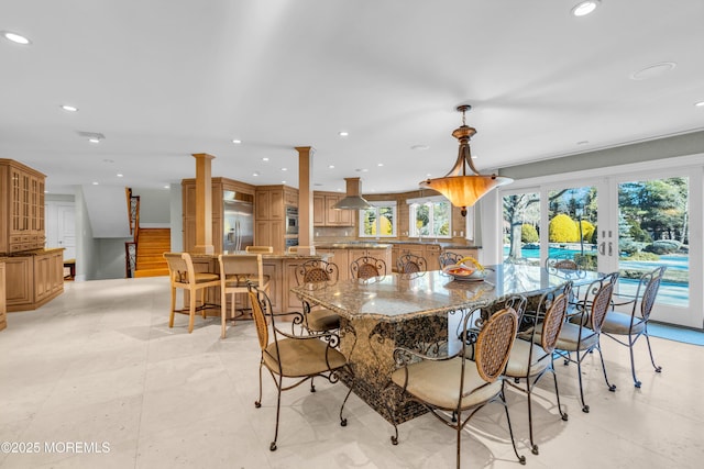 dining room with recessed lighting, french doors, and decorative columns