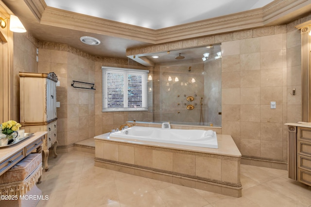 bathroom with a garden tub, a tile shower, tile patterned flooring, crown molding, and tile walls