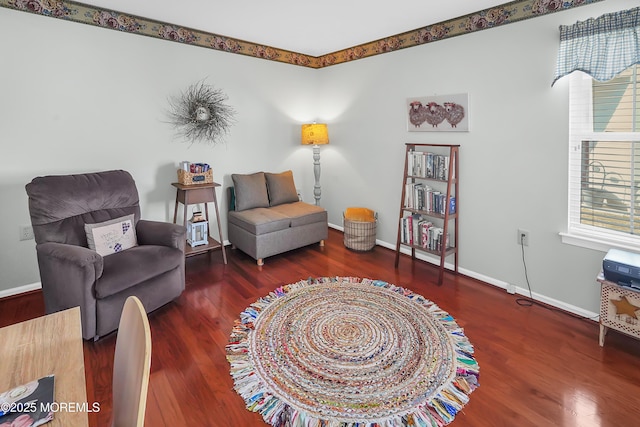 sitting room featuring baseboards and wood finished floors