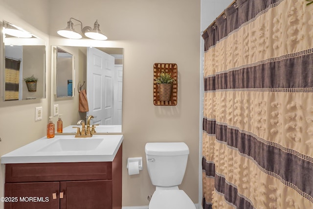 bathroom featuring toilet, a shower with curtain, and vanity