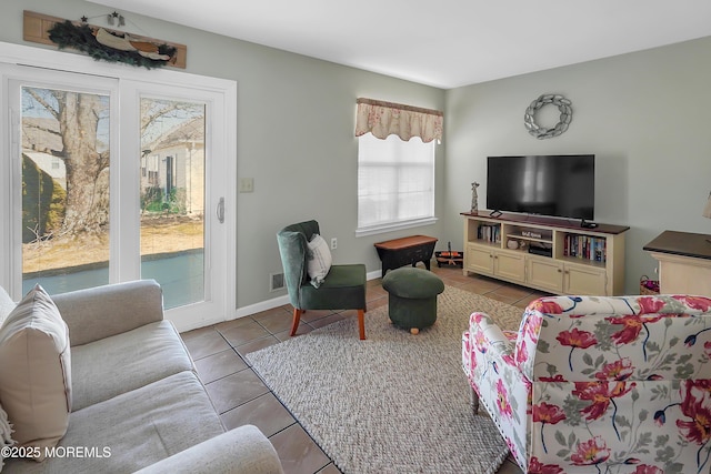 living room with tile patterned flooring and baseboards