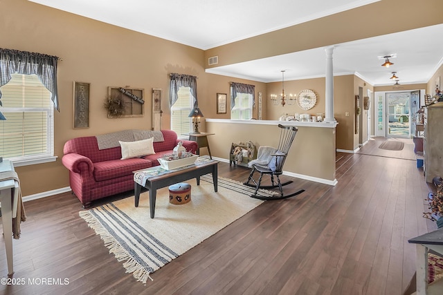 living room featuring hardwood / wood-style flooring, decorative columns, visible vents, and baseboards