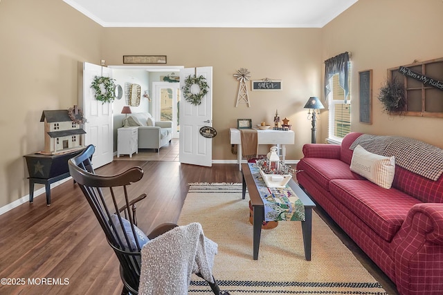 living area with ornamental molding, wood finished floors, and baseboards