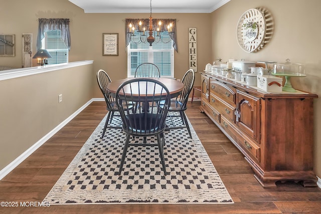 dining space featuring ornamental molding, a notable chandelier, dark wood finished floors, and baseboards